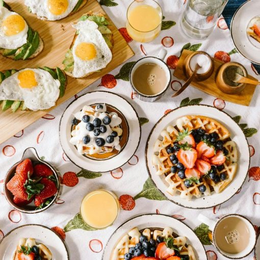 breakfast spread with waffles eggs and juice