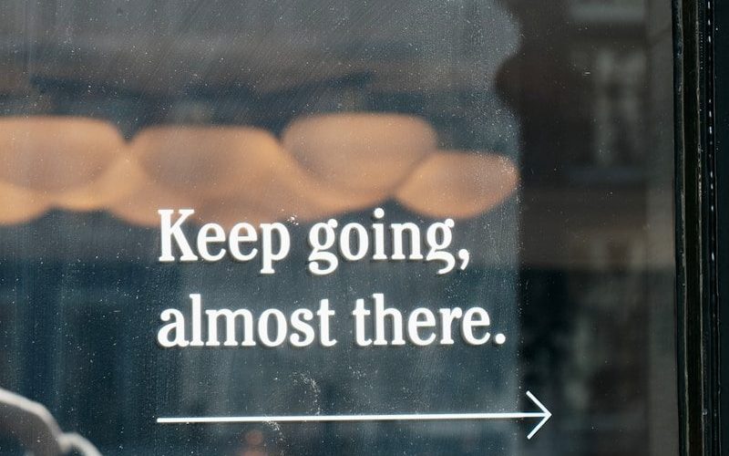 a window with a sign that says keep going, almost there